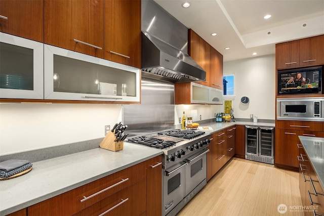 1514 Alki Ave SW, Seattle, WA 98116 - kitchen with wine cooler, stainless steel appliances, modern cabinets, wall chimney range hood, and light countertops