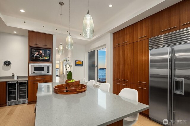 1514 Alki Ave SW, Seattle, WA 98116 - kitchen with built in appliances, wine cooler, modern cabinets, recessed lighting, and light wood finished floors