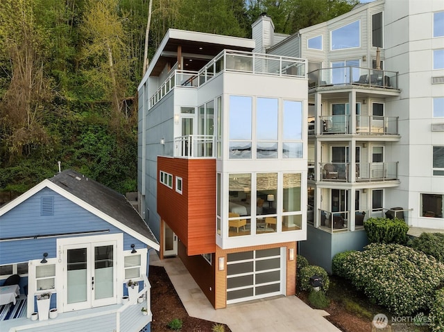 1514 Alki Ave SW, Seattle, WA 98116 - view of front of property with an attached garage, concrete driveway, and a chimney