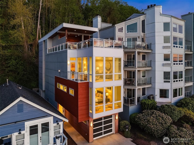 1514 Alki Ave SW, Seattle, WA 98116 - rear view of house with a garage, a balcony, and a chimney