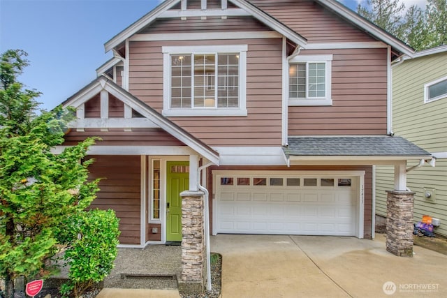 craftsman house featuring a garage, driveway, a shingled roof, and stone siding