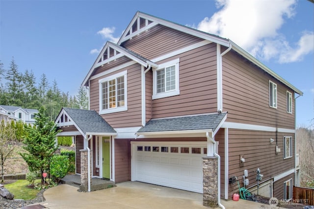 craftsman inspired home with a shingled roof, concrete driveway, stone siding, and a garage