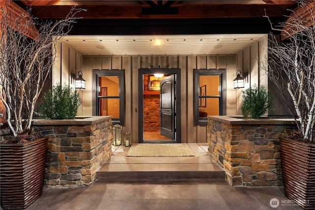 doorway to property with board and batten siding and a porch