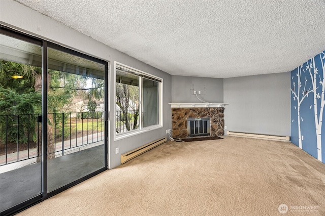 unfurnished living room with baseboard heating, a stone fireplace, carpet flooring, and a textured ceiling