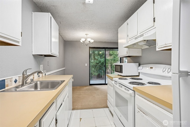 kitchen with under cabinet range hood, light countertops, white cabinets, white appliances, and a sink