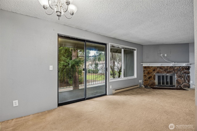 unfurnished living room with a baseboard radiator, carpet, a stone fireplace, and an inviting chandelier