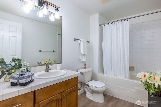 full bath with vanity, shower / tub combo, wood finished floors, and toilet