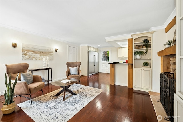 interior space with a fireplace with raised hearth, baseboards, dark wood finished floors, and crown molding