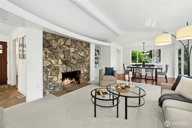 living room featuring vaulted ceiling with beams, a chandelier, a stone fireplace, visible vents, and baseboards