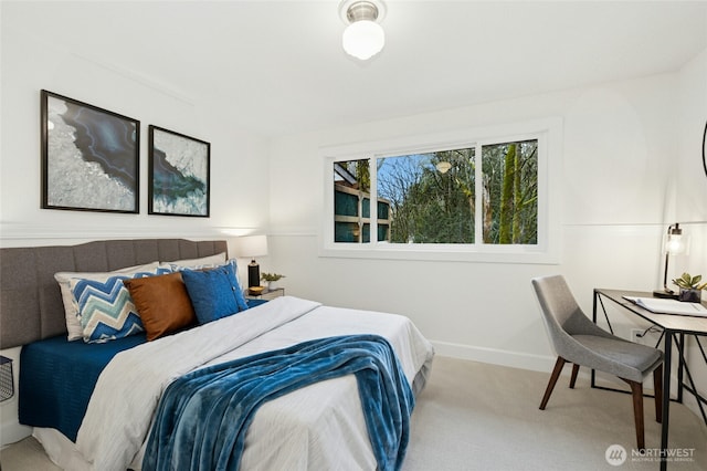 carpeted bedroom featuring baseboards