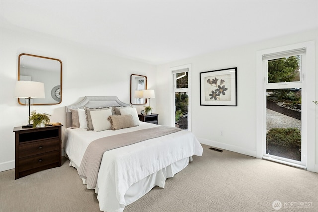 bedroom with carpet floors, access to outside, visible vents, and baseboards