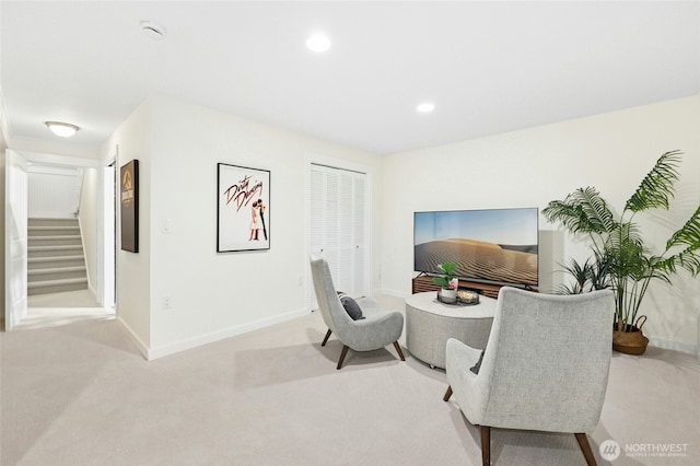 sitting room with carpet floors, recessed lighting, baseboards, and stairs