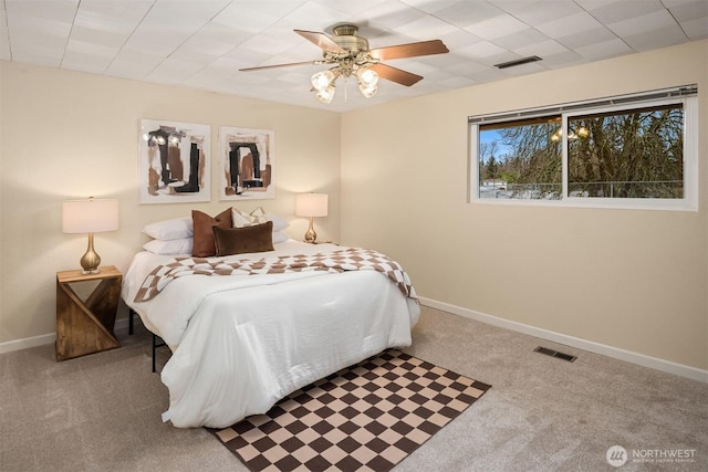 bedroom with carpet, visible vents, and baseboards