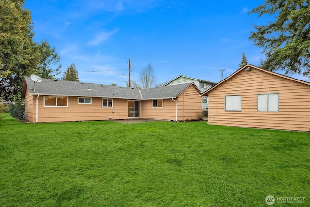 rear view of property with a yard