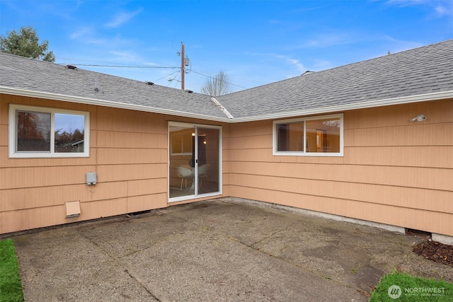 exterior space with a patio, crawl space, and roof with shingles