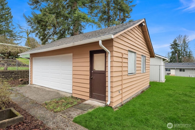 detached garage featuring fence