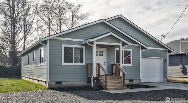 view of front facade featuring a garage, crawl space, and driveway