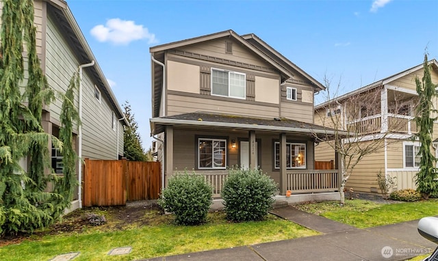 view of front of house with covered porch and fence