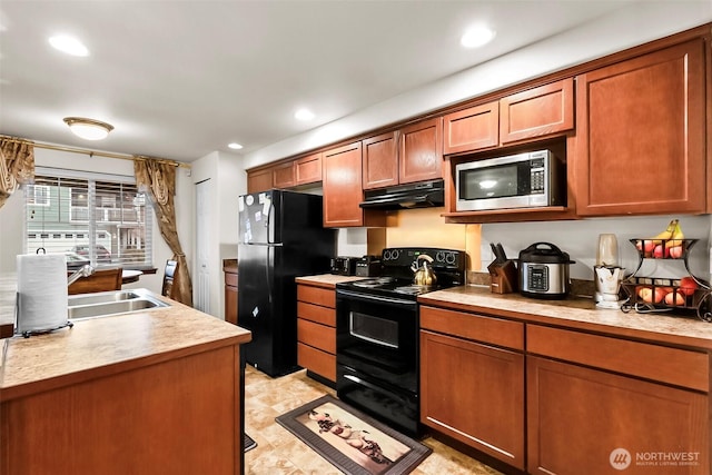 kitchen with recessed lighting, light countertops, under cabinet range hood, and black appliances