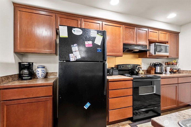 kitchen featuring black appliances, recessed lighting, brown cabinets, and under cabinet range hood