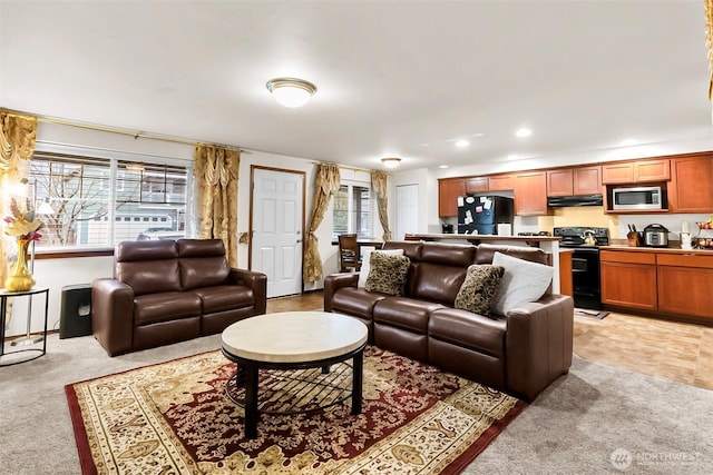 living room with light carpet and recessed lighting