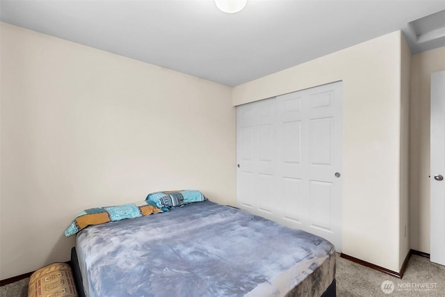 bedroom featuring light carpet and baseboards