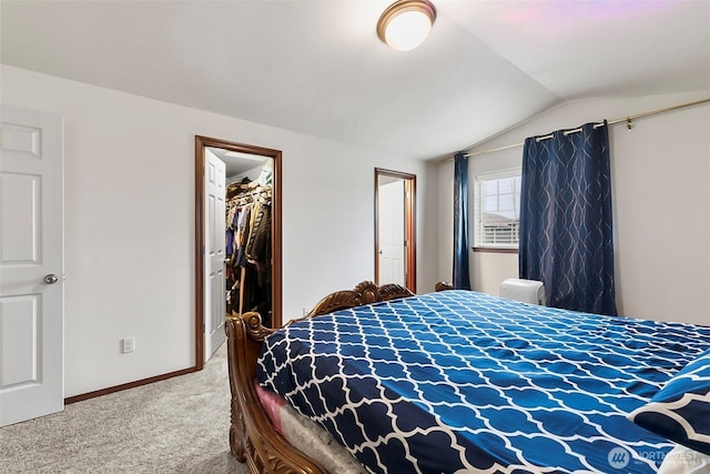 bedroom featuring baseboards, a spacious closet, vaulted ceiling, carpet floors, and a closet