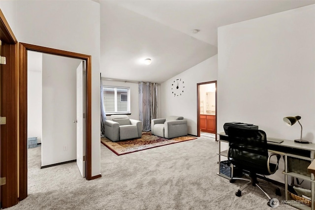 carpeted office with lofted ceiling