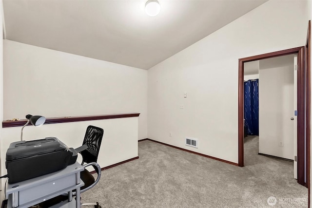 office area featuring lofted ceiling, carpet, visible vents, and baseboards