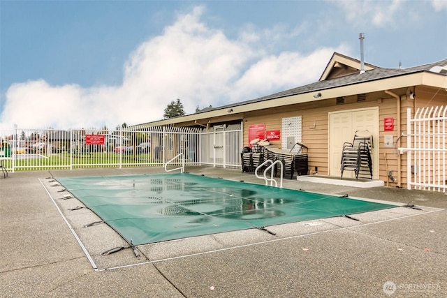 pool featuring fence and a patio