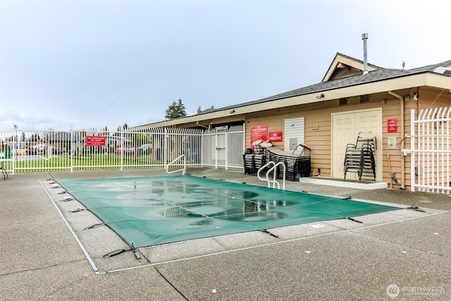 community pool featuring a patio area and fence