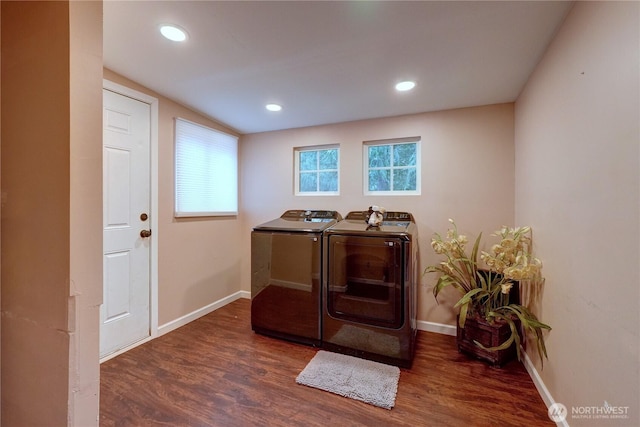 laundry area with baseboards, wood finished floors, and washer and dryer