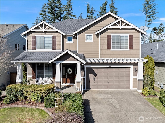 craftsman-style house featuring covered porch, concrete driveway, roof with shingles, and a garage