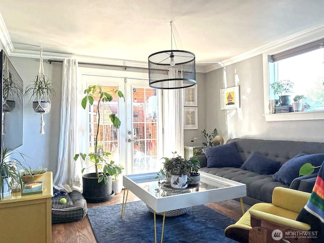 living area with ornamental molding, french doors, and wood finished floors