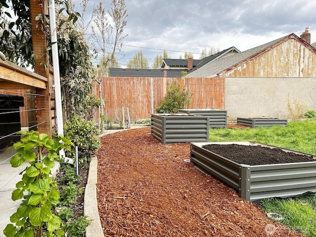 view of yard featuring a vegetable garden and fence