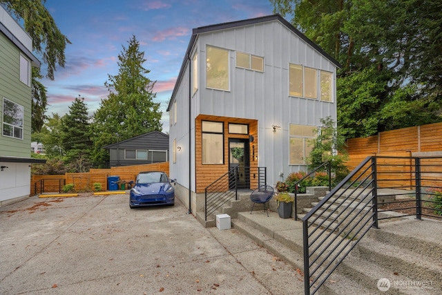 view of front of home with board and batten siding and fence