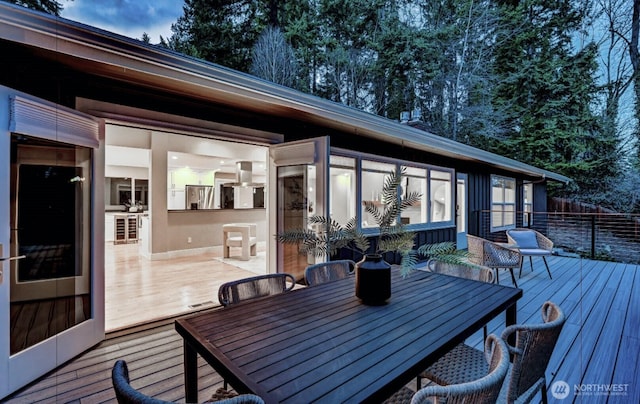 wooden terrace featuring outdoor dining area