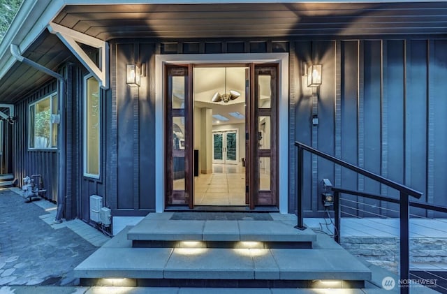 view of exterior entry with board and batten siding