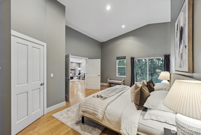 bedroom with light wood-style flooring, high vaulted ceiling, baseboards, and recessed lighting