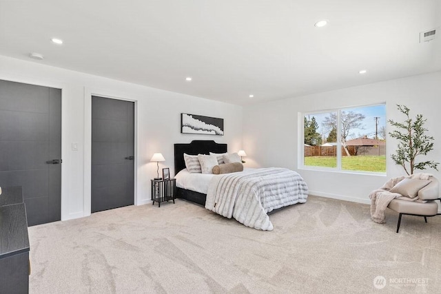 carpeted bedroom featuring recessed lighting, visible vents, and baseboards