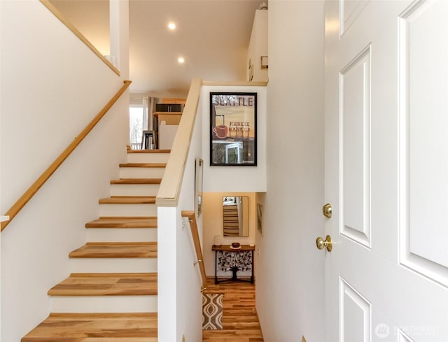 stairway with recessed lighting and wood finished floors