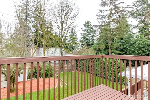 wooden deck with a lawn