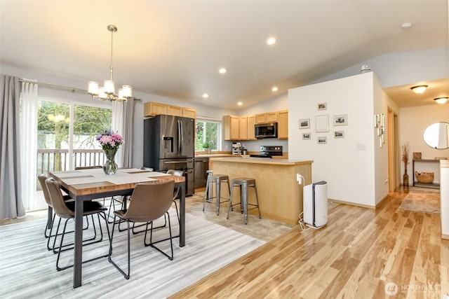 dining space with recessed lighting, baseboards, vaulted ceiling, light wood-style floors, and an inviting chandelier