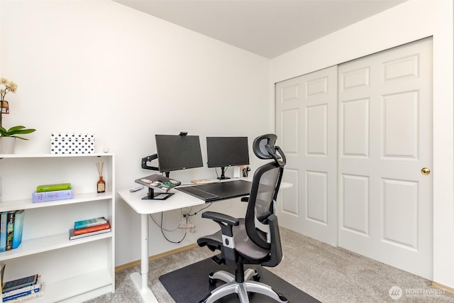 carpeted home office featuring baseboards