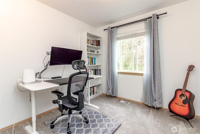 home office with carpet, visible vents, and baseboards