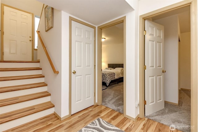 stairs featuring baseboards and wood finished floors