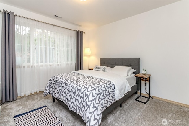 bedroom featuring carpet flooring, visible vents, and baseboards