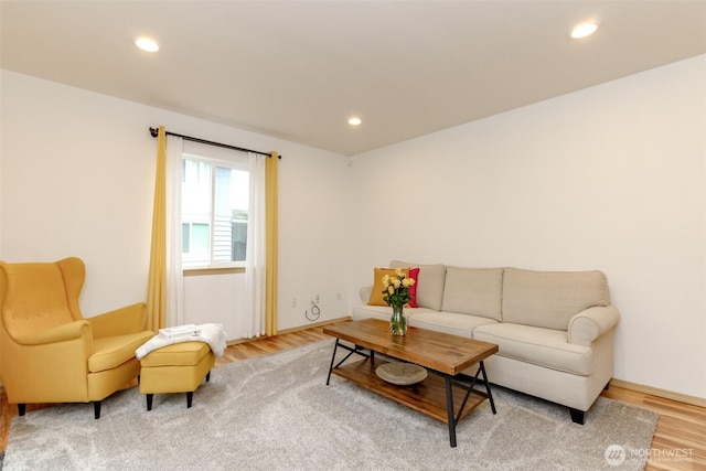 living area with wood finished floors and recessed lighting