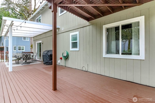 wooden deck with grilling area and outdoor dining space