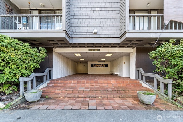 entrance to property featuring a balcony and a carport